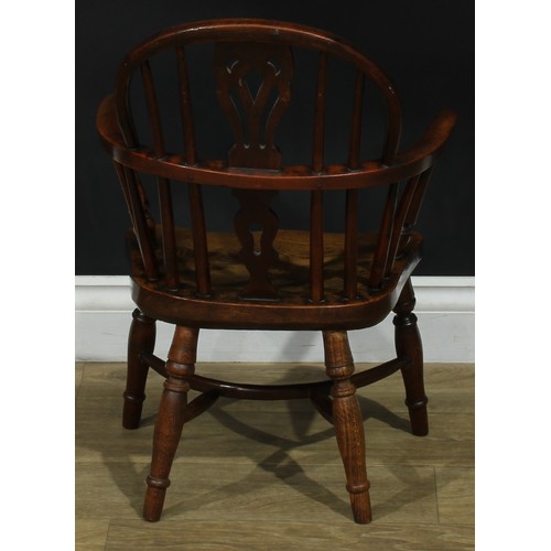 1009 - A 19th century yew and elm miniature Windsor elbow chair, hoop back, shaped and pierced splat, turne... 