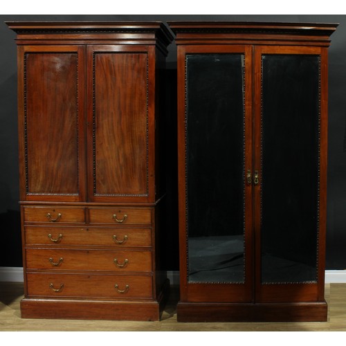 1176 - A George III Revival mahogany two-piece bedroom suite, comprising linen press and wardrobe, the line... 