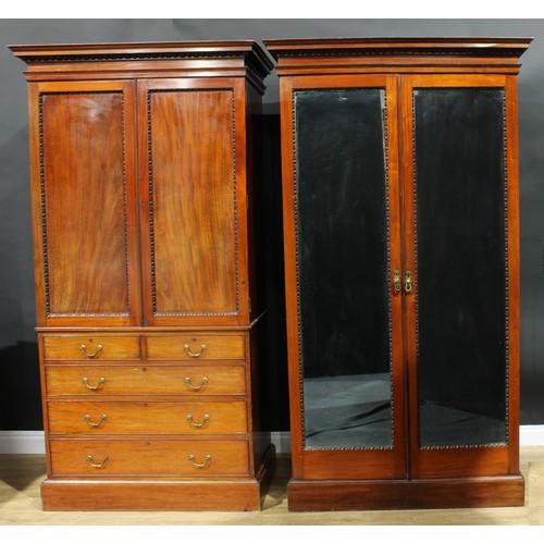 1176 - A George III Revival mahogany two-piece bedroom suite, comprising linen press and wardrobe, the line... 