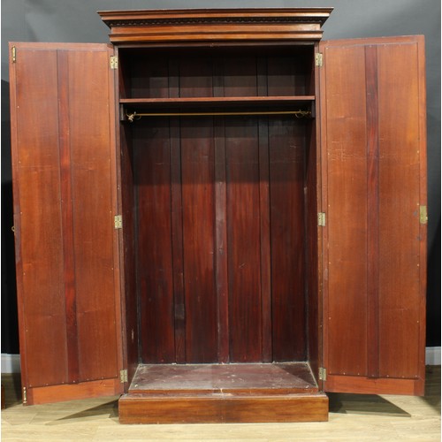 1176 - A George III Revival mahogany two-piece bedroom suite, comprising linen press and wardrobe, the line... 