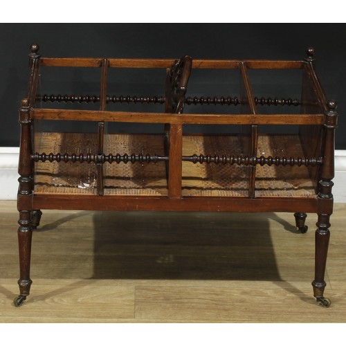 892 - A 19th century Colonial four section Canterbury, bobbin-turned side rails, wicker base, turned legs,... 