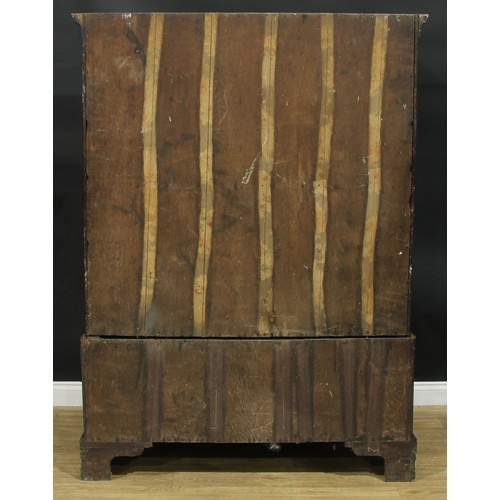 1223 - A George III mahogany linen press, outswept cornice above a pair of raised and fielded panel doors e... 