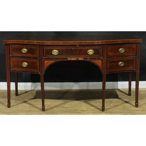 1445 - A Sheraton Revival satinwood crossbanded mahogany serpentine sideboard, slightly oversailing top abo... 