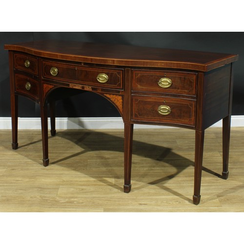 1445 - A Sheraton Revival satinwood crossbanded mahogany serpentine sideboard, slightly oversailing top abo... 