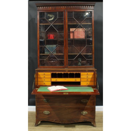 1226 - A George III mahogany secretaire bookcase, outswept cornice above a pair of astragal glazed doors en... 