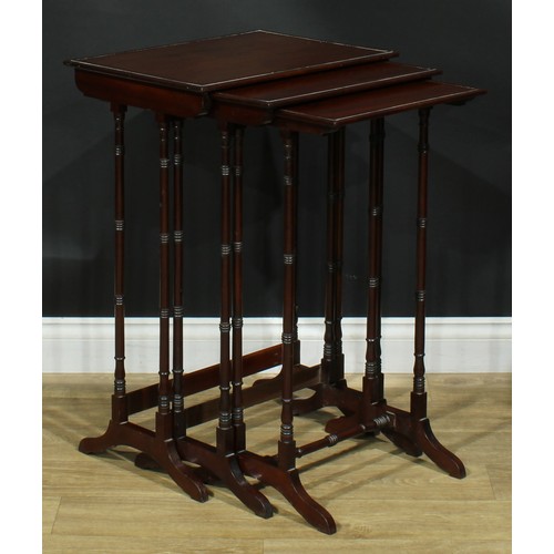 1370 - A nest of three George III Revival mahogany occasional tables, each with a rectangular top, turned s... 