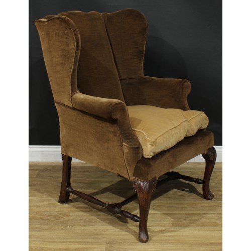 1098 - A George II Revival wingback armchair, stuffed-over upholstery, squab cushion, cabriole forelegs, H-... 