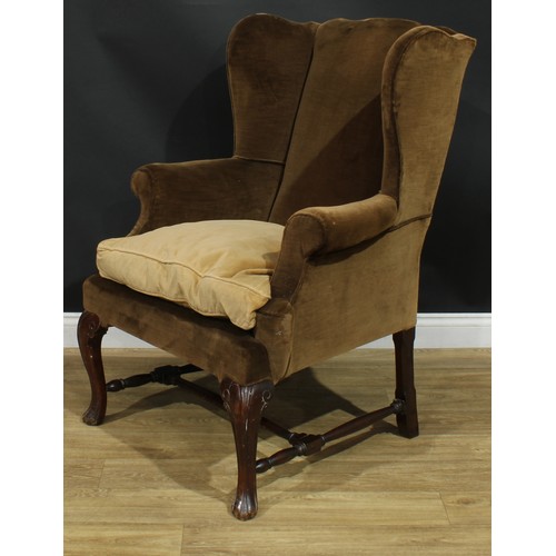 1098 - A George II Revival wingback armchair, stuffed-over upholstery, squab cushion, cabriole forelegs, H-... 