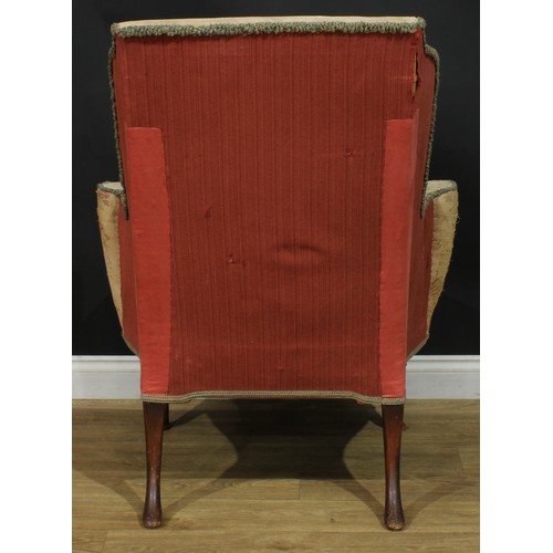 1099 - A George II Revival wingback armchair, stuffed-over upholstery, squab cushion, cabriole forelegs, pa... 