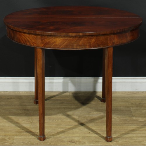 1115 - A George III mahogany demilune tea table, hinged top, tapered square legs, one rear concealing a sec... 