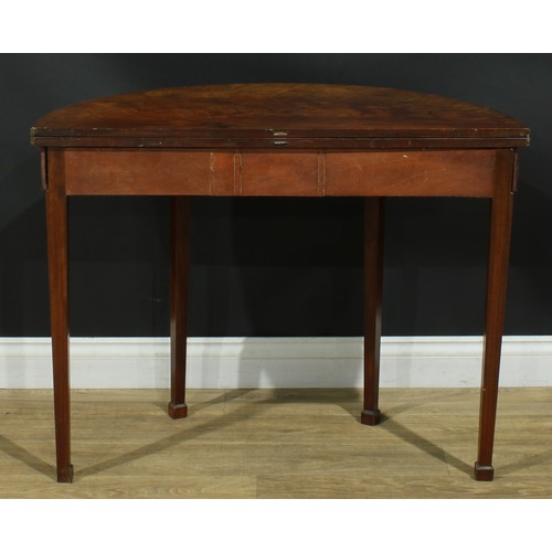 1115 - A George III mahogany demilune tea table, hinged top, tapered square legs, one rear concealing a sec... 