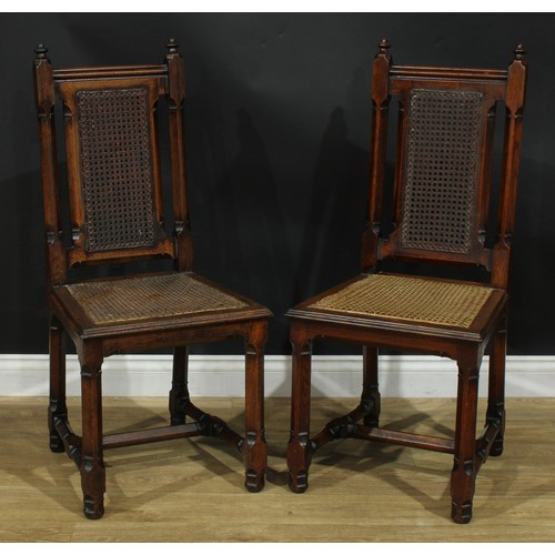 1398 - A pair of Gothic Revival oak hall chairs, cane back and seat, 104cm high, 47cm wide, the seat 39cm d... 