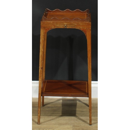 1175 - A George III Revival mahogany kettle stand, square top with wavy gallery, above a slide, batwing bra... 