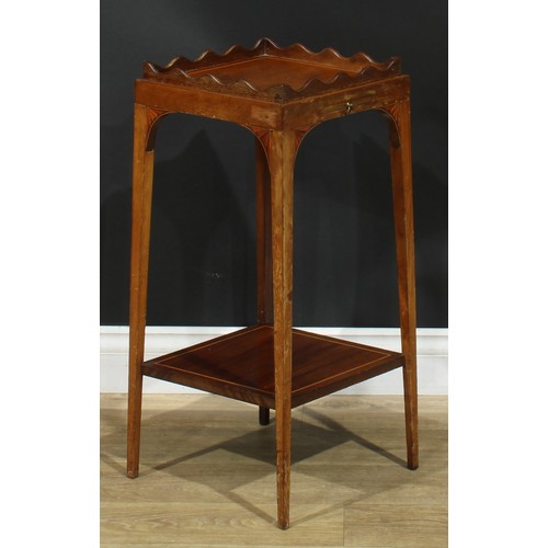 1175 - A George III Revival mahogany kettle stand, square top with wavy gallery, above a slide, batwing bra... 