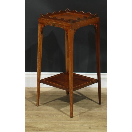 1175 - A George III Revival mahogany kettle stand, square top with wavy gallery, above a slide, batwing bra... 