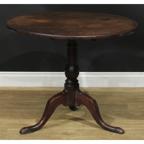 1236 - A George III mahogany tripod occasional table, one-piece circular tilting top, turned column, cabrio... 