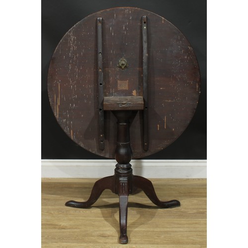 1236 - A George III mahogany tripod occasional table, one-piece circular tilting top, turned column, cabrio... 