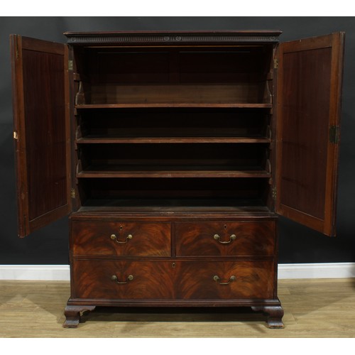 1222 - A George III mahogany linen press, nulled cornice above a pair of flame veneered panel doors enclosi... 