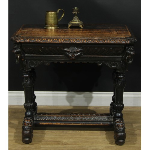 1325 - A late 19th century oak centre table, canted rectangular top with foliate carved edge above a long f... 