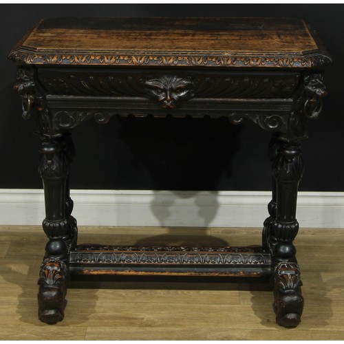 1325 - A late 19th century oak centre table, canted rectangular top with foliate carved edge above a long f... 