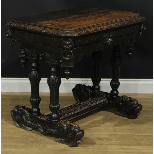 1325 - A late 19th century oak centre table, canted rectangular top with foliate carved edge above a long f... 