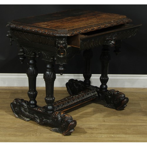 1325 - A late 19th century oak centre table, canted rectangular top with foliate carved edge above a long f... 