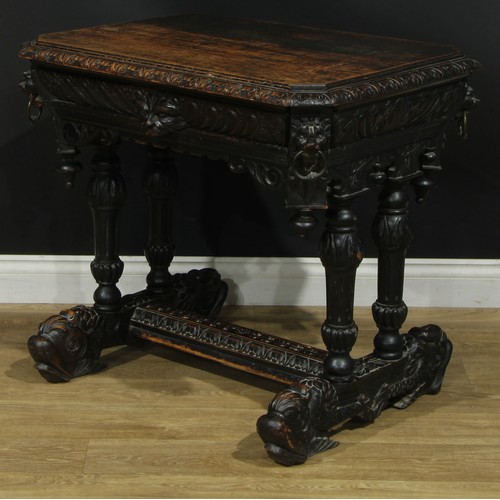 1325 - A late 19th century oak centre table, canted rectangular top with foliate carved edge above a long f... 