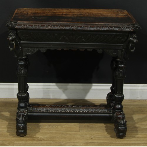 1325 - A late 19th century oak centre table, canted rectangular top with foliate carved edge above a long f... 