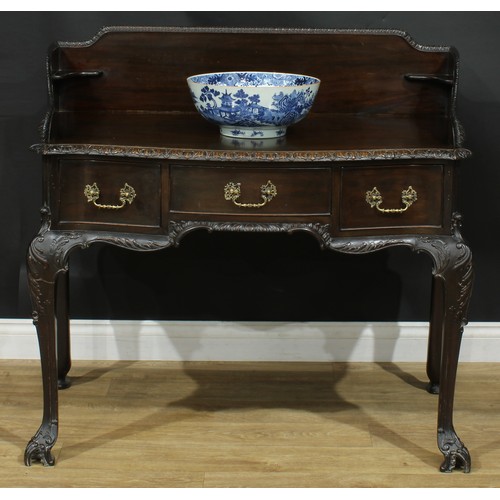 1097 - A George II Revival mahogany serpentine washstand, shaped three-quarter gallery above three frieze d... 