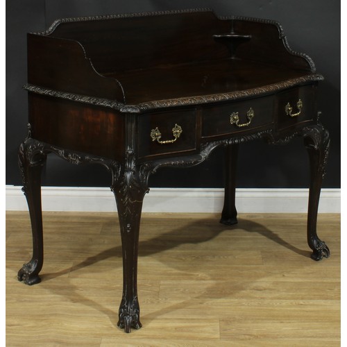 1097 - A George II Revival mahogany serpentine washstand, shaped three-quarter gallery above three frieze d... 