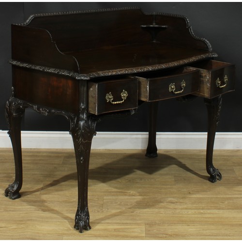 1097 - A George II Revival mahogany serpentine washstand, shaped three-quarter gallery above three frieze d... 