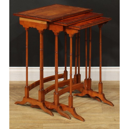 1178 - A George III Revival satinwoood nest of three occasional tables, each with a rectangular top and rin... 