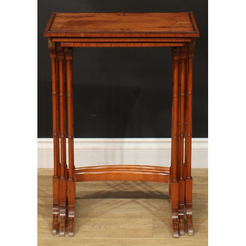 1178 - A George III Revival satinwoood nest of three occasional tables, each with a rectangular top and rin... 