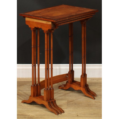 1178 - A George III Revival satinwoood nest of three occasional tables, each with a rectangular top and rin... 