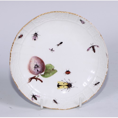 524 - A Meissen cup and saucer, painted in polychrome with insects, fruit and pea pods, on a moulded groun... 