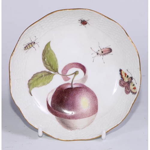 523 - A Meissen cup and saucer, painted in polychrome with insects, fruit and fungi, on a moulded ground, ... 