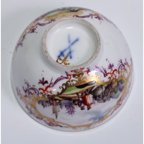 525 - A Meissen tea bowl and saucer, painted in polychrome with harbour views, gilt borders, the saucer 12... 