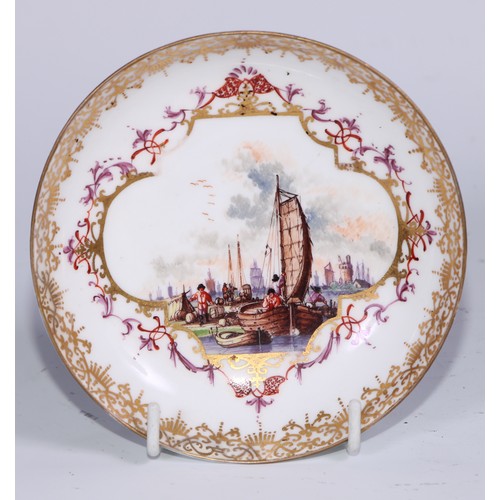 525 - A Meissen tea bowl and saucer, painted in polychrome with harbour views, gilt borders, the saucer 12... 