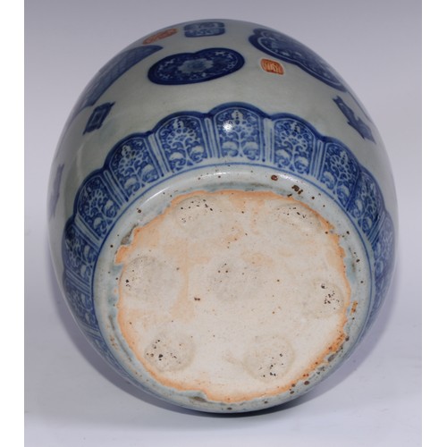 754 - A Japanese barrel shaped jardiniere decorated in tones of underglaze blue with fans, lappets and res... 