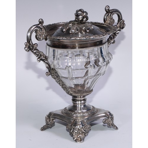 77 - A 19th century French silver and clear glass sweetmeat urn and cover, chased with scrolling acanthus... 