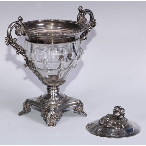 77 - A 19th century French silver and clear glass sweetmeat urn and cover, chased with scrolling acanthus... 