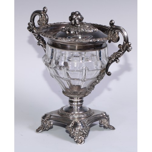 77 - A 19th century French silver and clear glass sweetmeat urn and cover, chased with scrolling acanthus... 