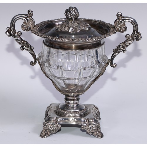 77 - A 19th century French silver and clear glass sweetmeat urn and cover, chased with scrolling acanthus... 