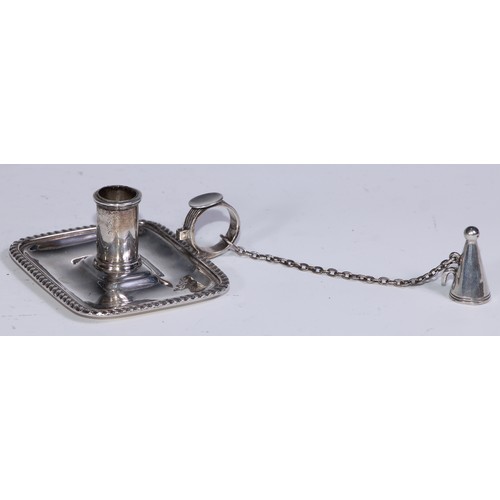 282 - An Edwardian silver rounded rectangular chamberstick, gadrooned border, conical snuffer, 8.5cm wide,... 