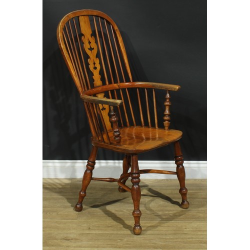 1011 - A 19th century Yorkshire Windsor elbow chair, hoop back, shaped and pierced Christmas tree splat, tu... 