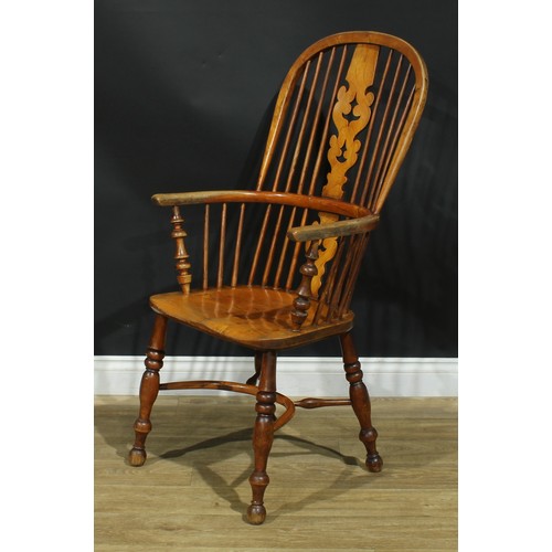 1011 - A 19th century Yorkshire Windsor elbow chair, hoop back, shaped and pierced Christmas tree splat, tu... 