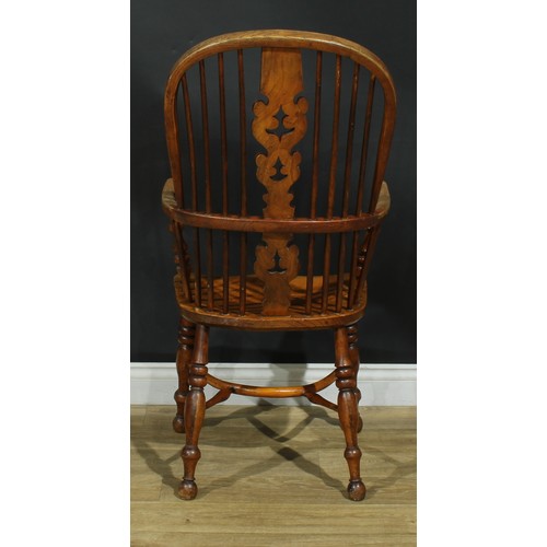 1011 - A 19th century Yorkshire Windsor elbow chair, hoop back, shaped and pierced Christmas tree splat, tu... 