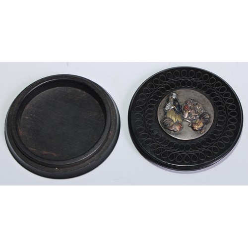 829 - A 19th century lignum vitae circular snuff box, engine turned and applied with a Japanese moxed meta... 