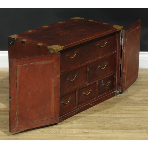 1021 - A Chinese brass mounted enclosed table cabinet, flush rectangular top above a pair of yumu veneer pa... 