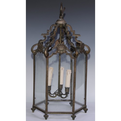 1306 - An early 20th century bronze hexagonal hall ceiling lantern, shaped arched crestings, each glazed pa... 